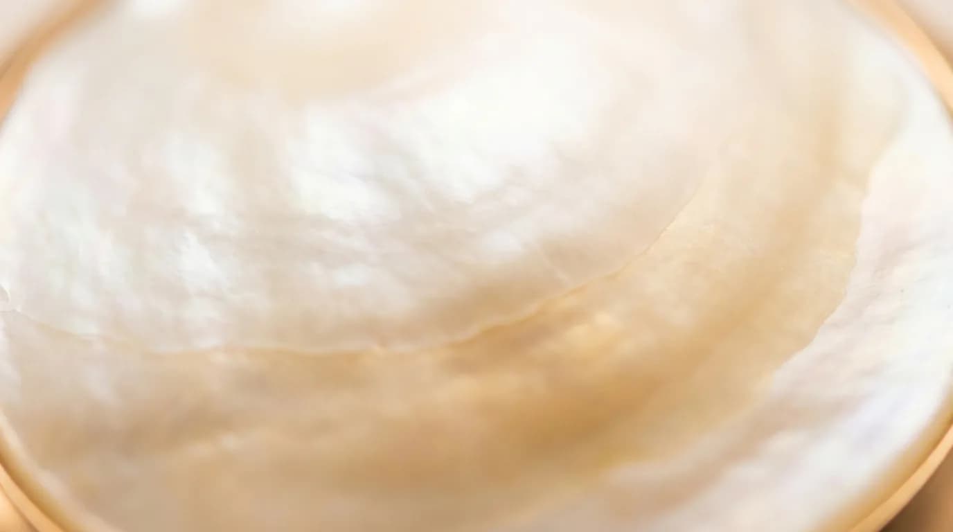 Macro shot of a mother of pearl inlay showing its natural grain